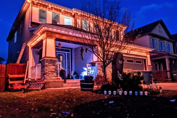 Permanent color-changing roofline lighting on a Central Florida home at night